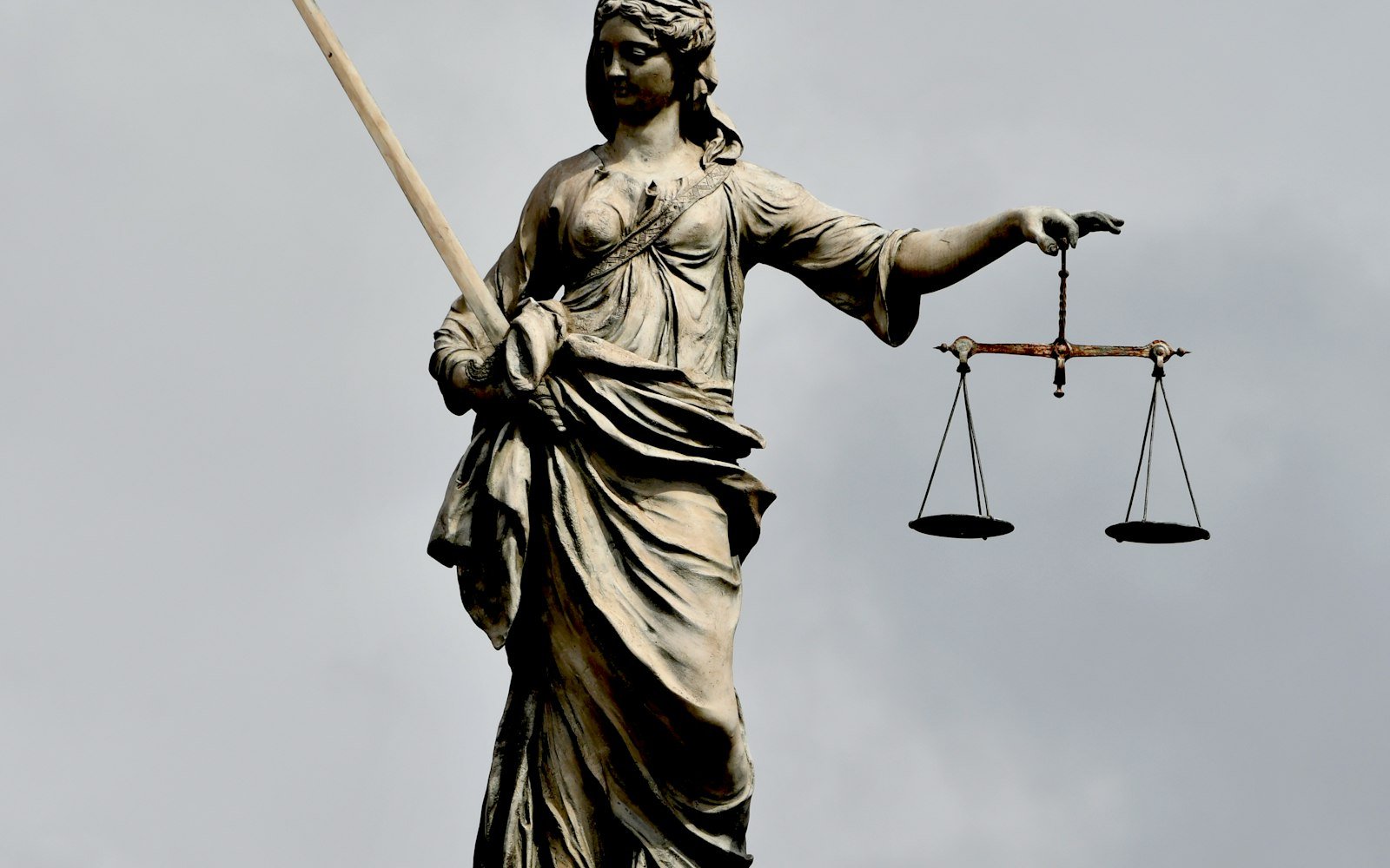 Statue of Justice holding a sword and scales