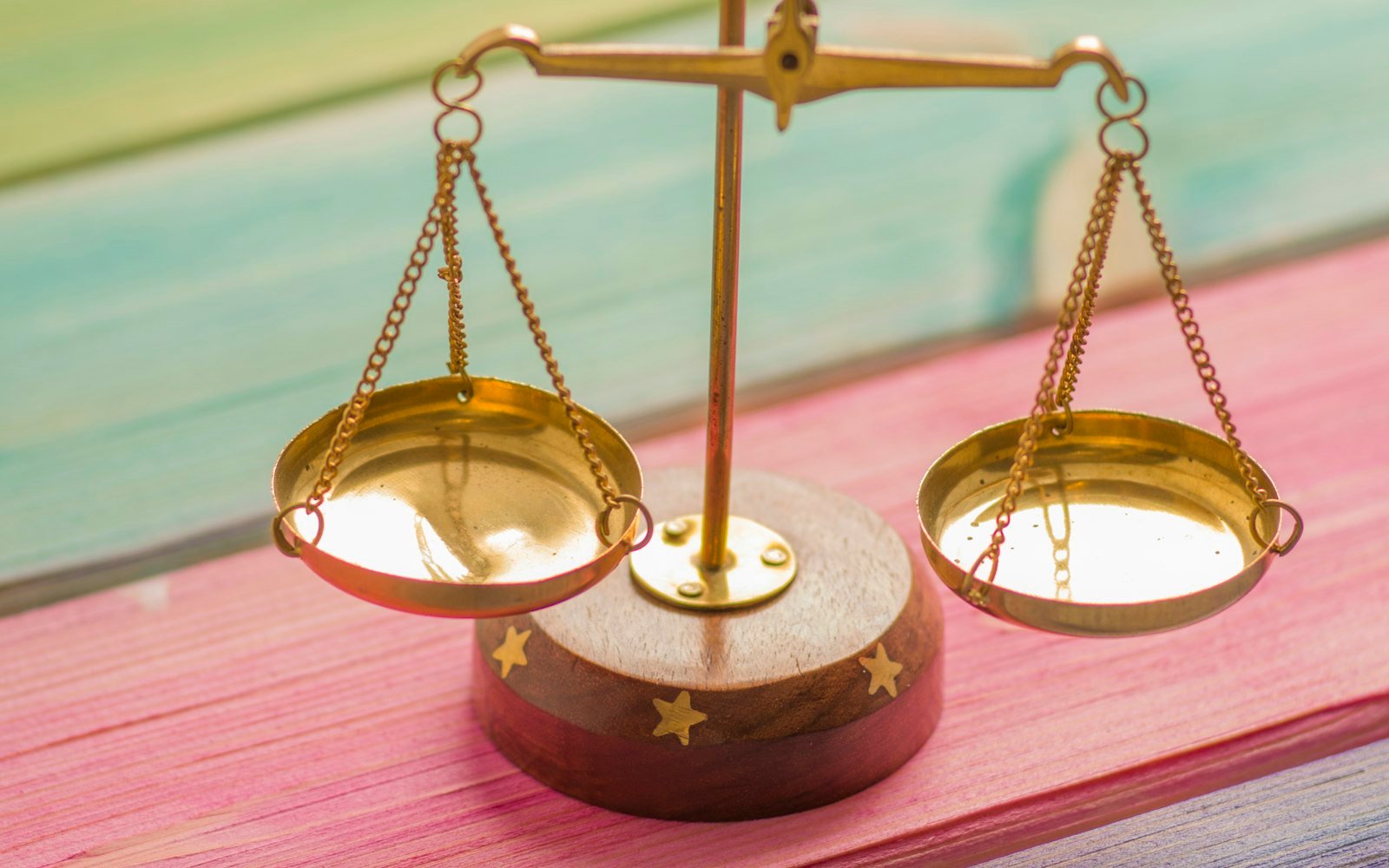 Brass scales of justice resting on books