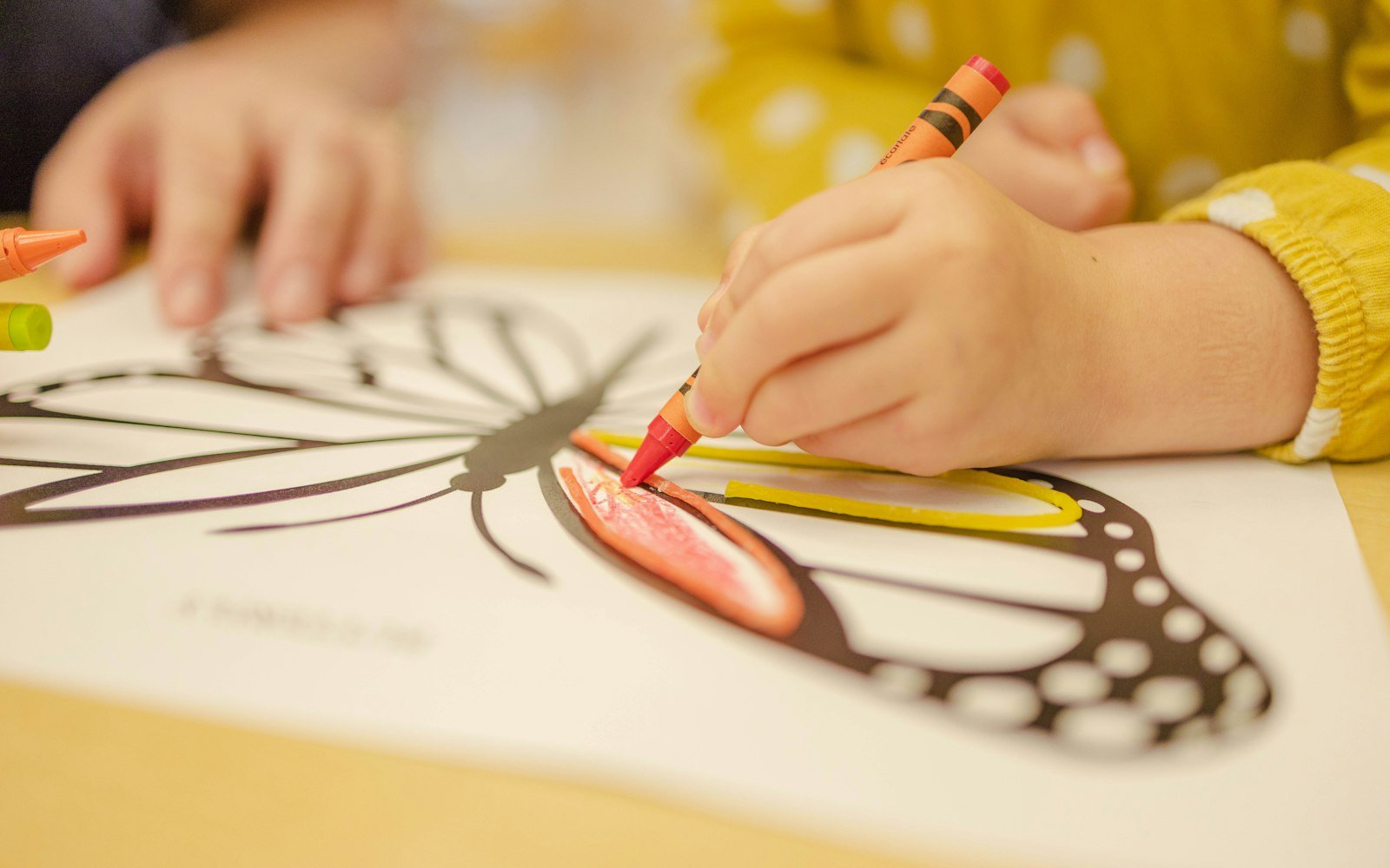 A child colouring a drawing with a crayon