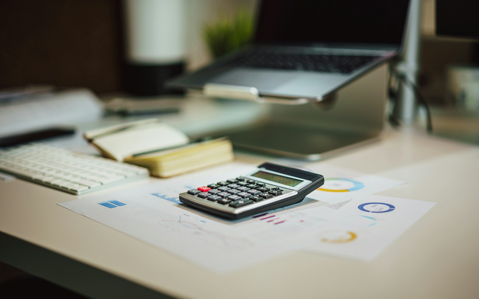 Desk with a calculator and laptop