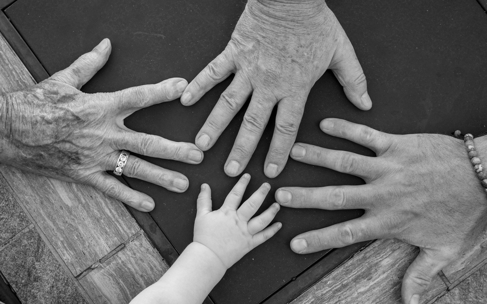 Hands of several generations of a family together