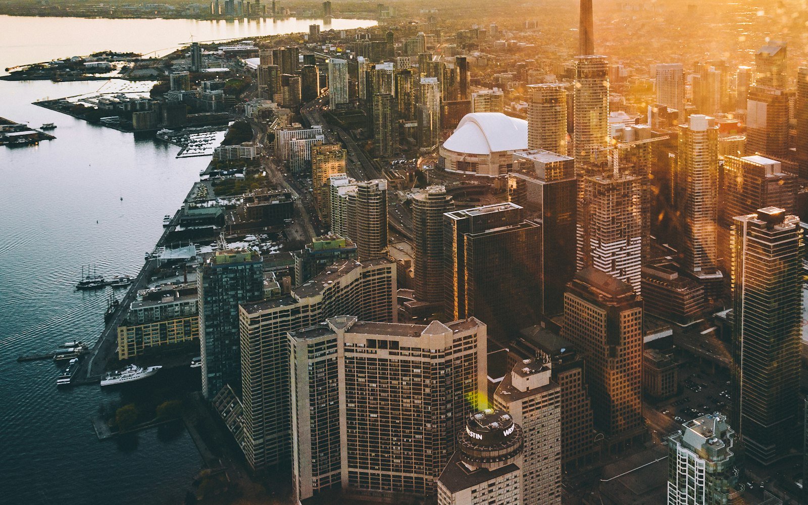 An aerial view of downtown Toronto and the CN Tower at golden hour