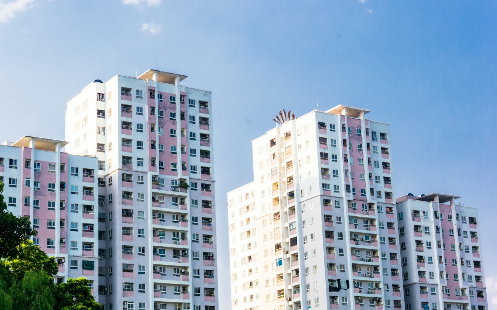 White high-rise residential buildings against a clear sky