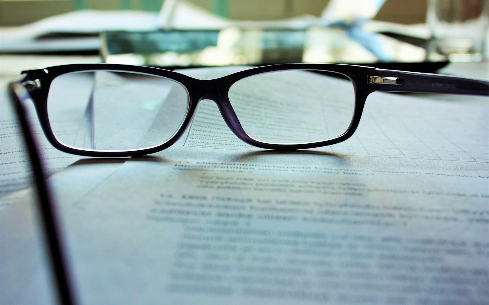 Reading glasses resting on a printed document