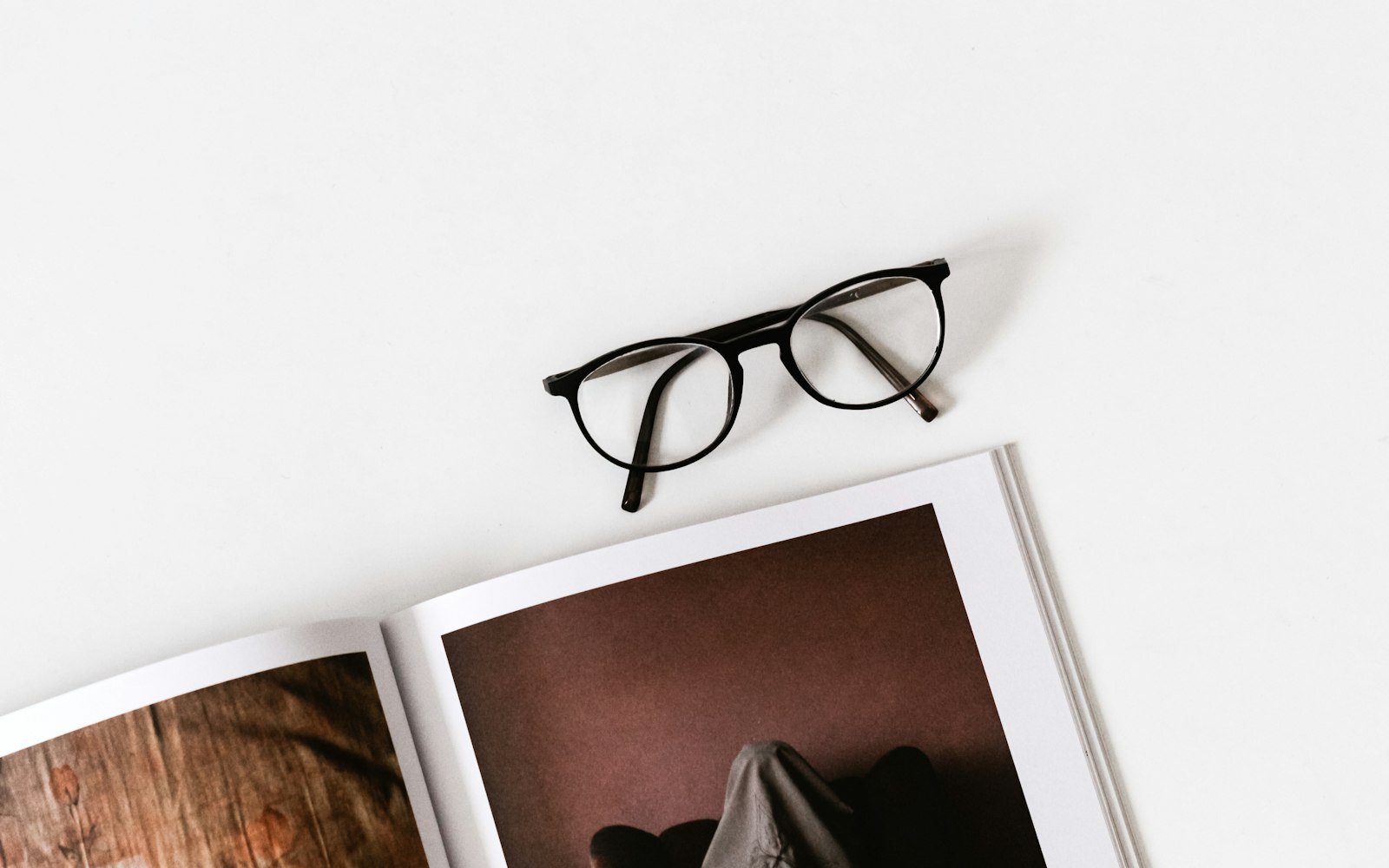 Reading glasses resting on an open photo album