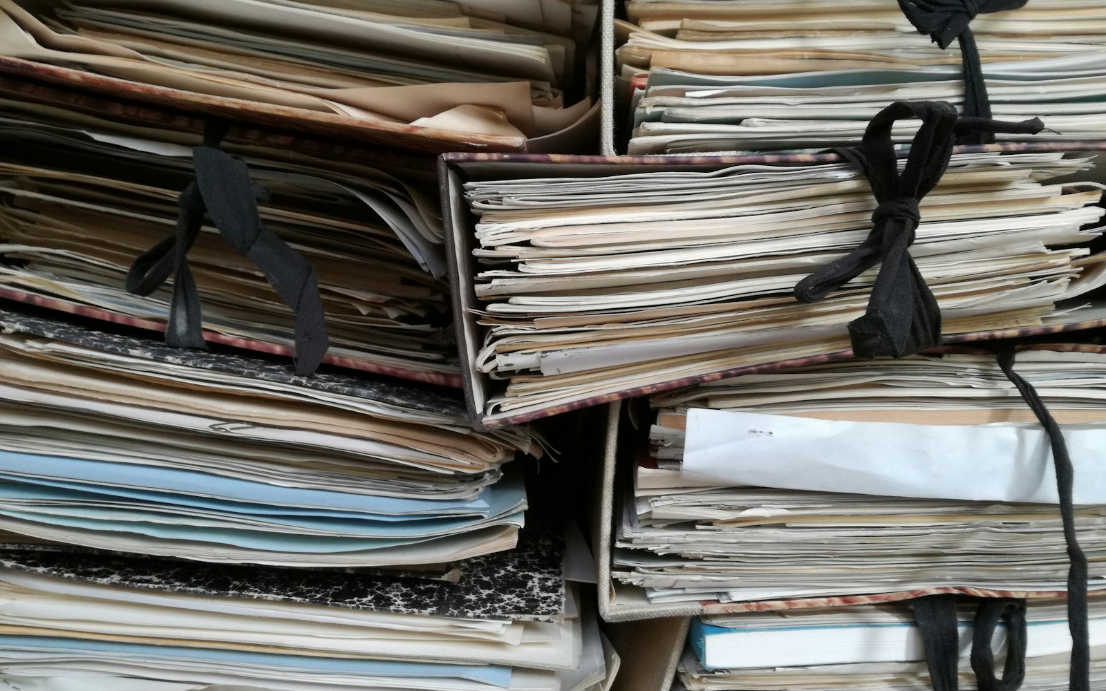 Old files tied with ribbon in stacks
